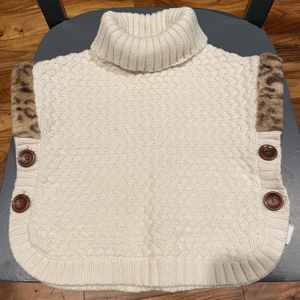 Aspen kids US 4 cable knit poncho with animal print trim.